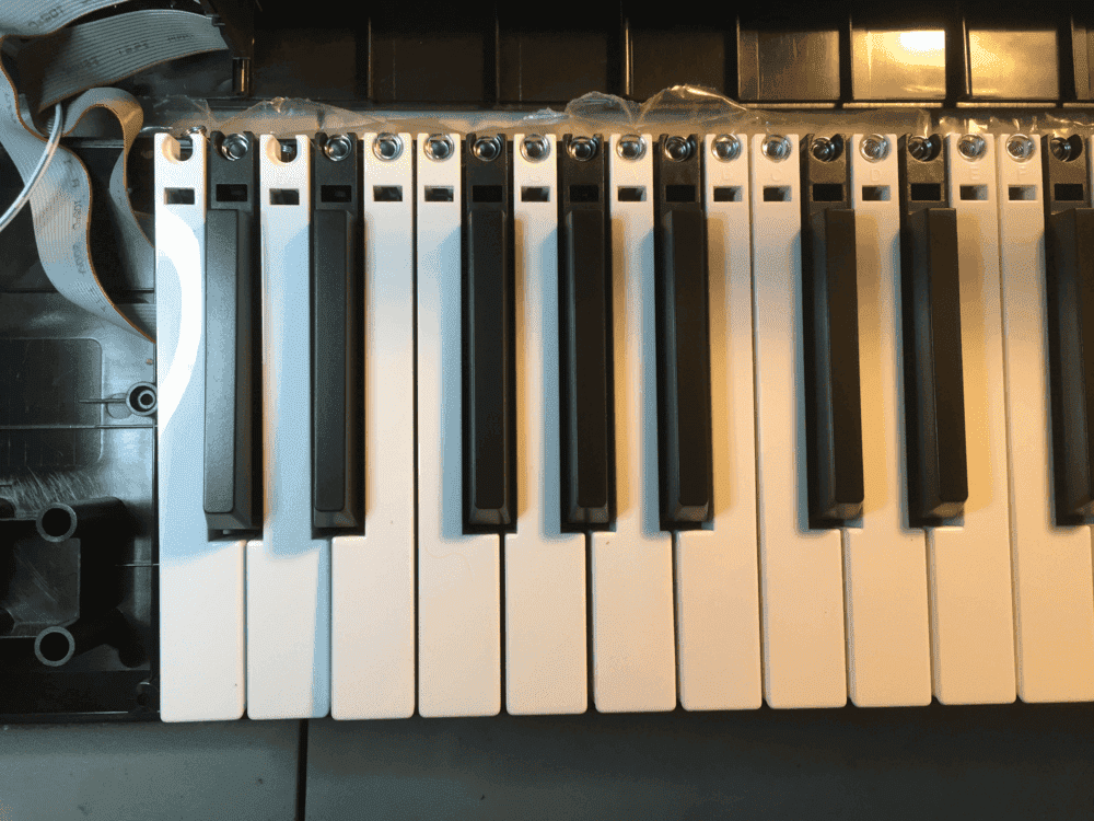 A standard piano keyboard juxtaposed with a 'balanced' keyboard