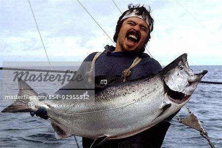 854-02955512em-commercial-fisherman-holding-a-large-king-salmon-caught-on-a-salmon.jpg