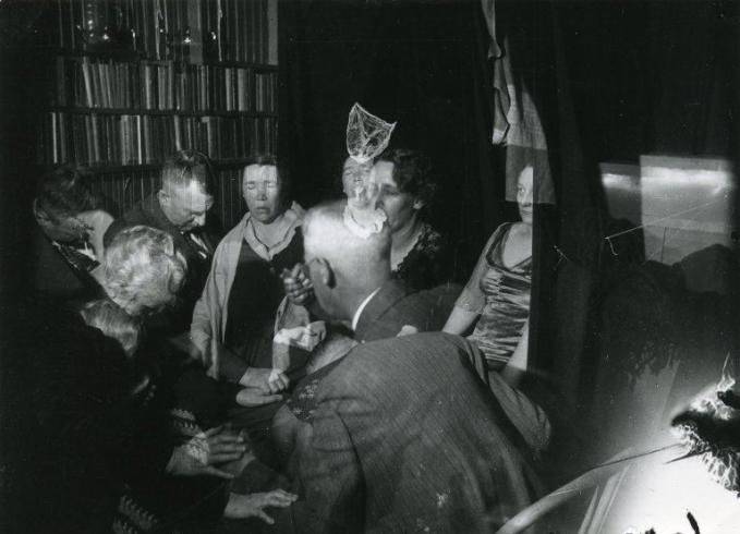 People-holding-hands-conducting-seance-679x.jpg
