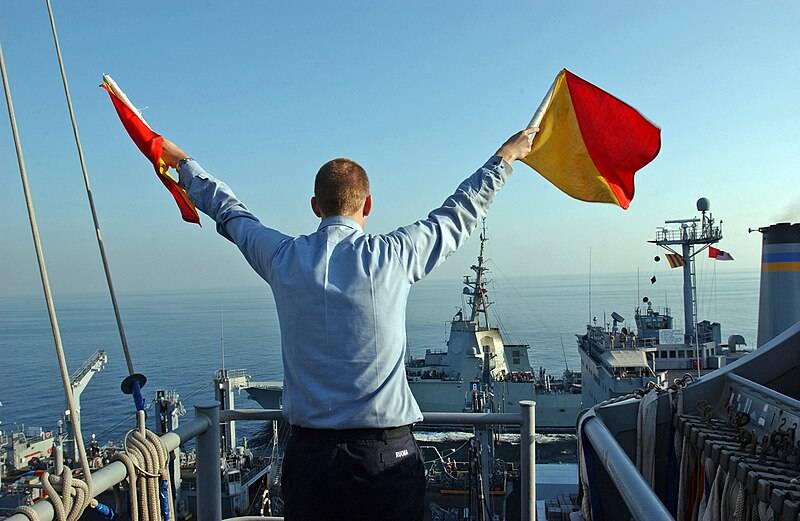 with_semaphore_flags_during_a_replenishment_at_sea.jpg