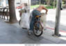 homeless-man-searching-for-redeemable-containers-in-a-trash-can-3rd-j477yt.jpg