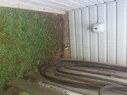 zoomed out view of drainage pipe in backyard.webp