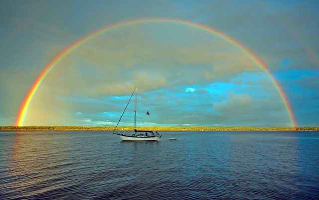 Rainbow over boat in water